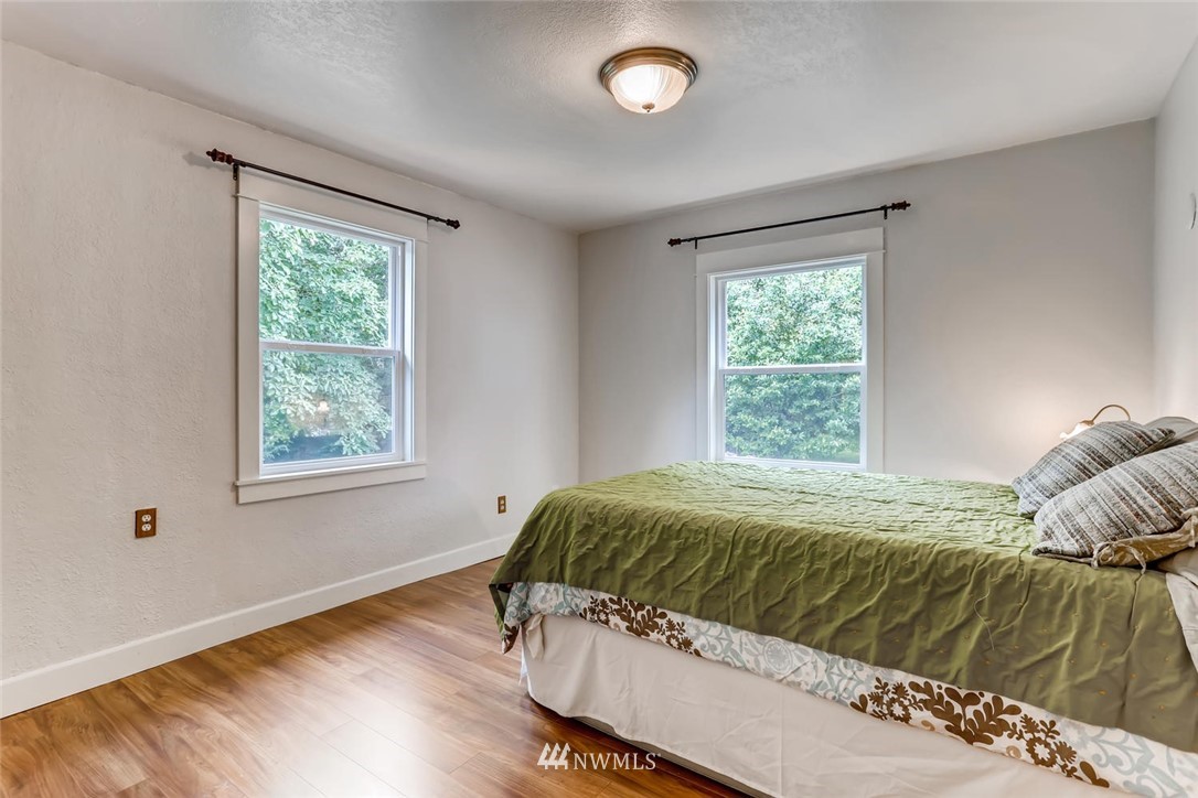 216 174th Street Southwest Bothell, WA 98012 - Photo 17 of 27 a bed sitting in a bedroom next to a window