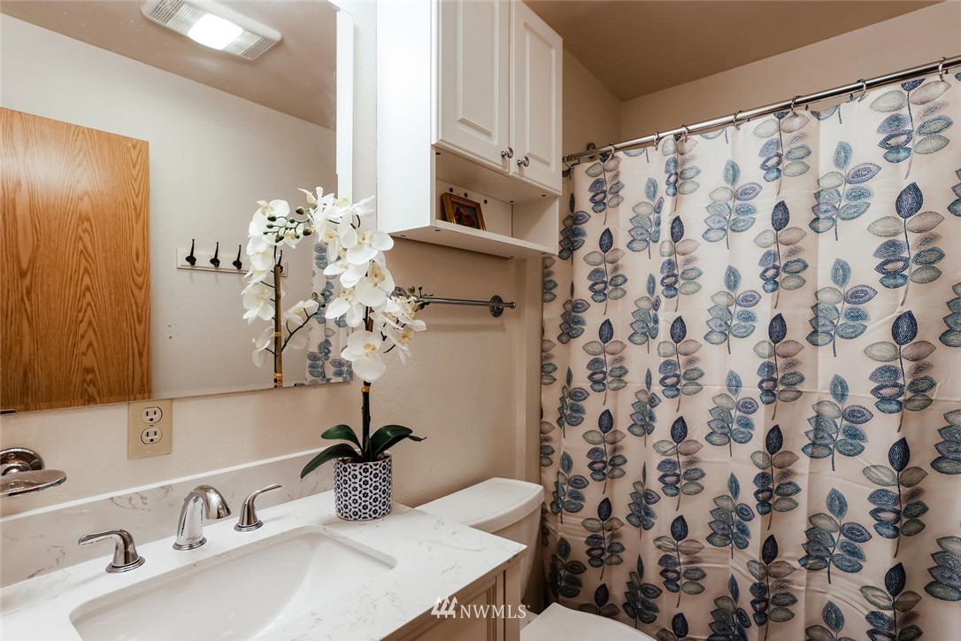 216 174th Street Southwest Bothell, WA 98012 - Photo 18 of 27 a bathroom with a sink and a mirror