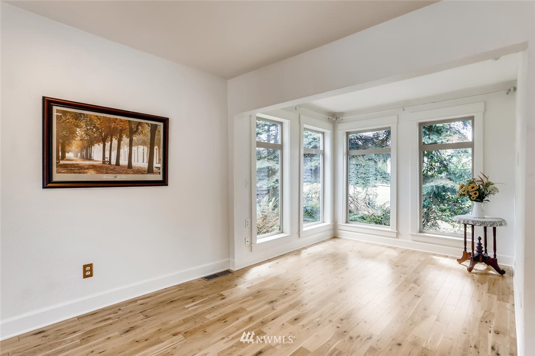 216 174th Street Southwest Bothell, WA 98012 - Photo 21 of 27 a view of an empty room with wooden floor and a window