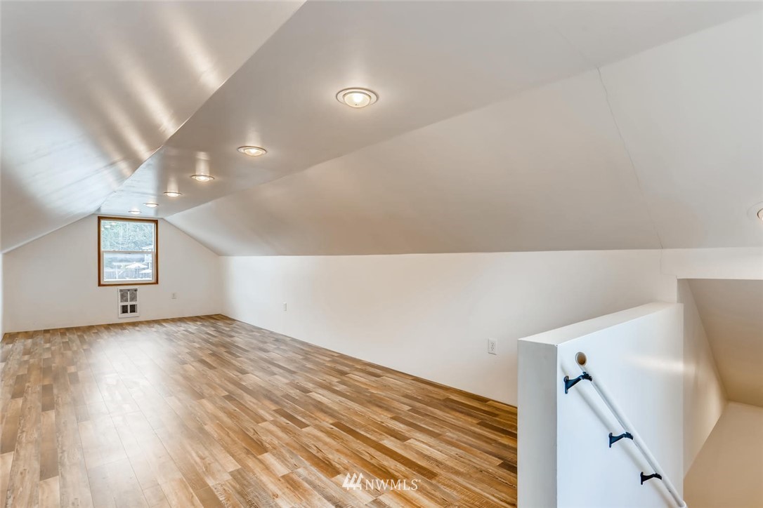 216 174th Street Southwest Bothell, WA 98012 - Photo 26 of 27 a view of an empty room with wooden floor and stairs