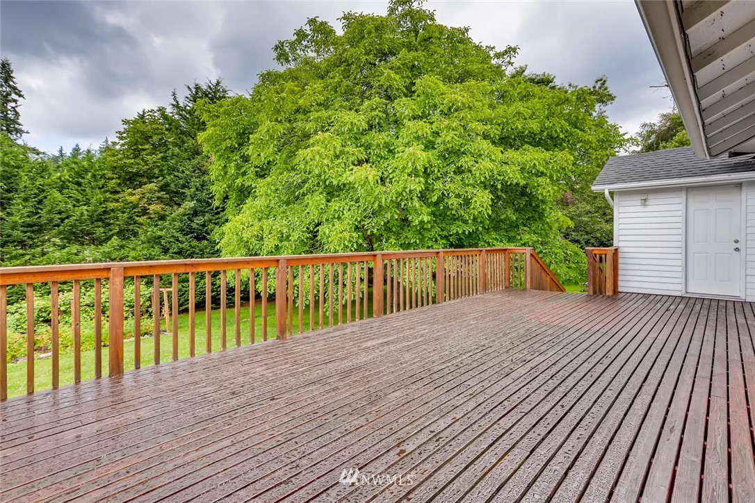 216 174th Street Southwest Bothell, WA 98012 - Photo 4 of 27 a balcony with wooden floor and fence