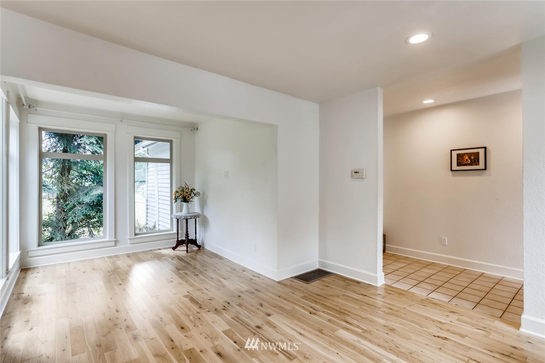 216 174th Street Southwest Bothell, WA 98012 - Photo 9 of 27 an empty room with wooden floor and windows