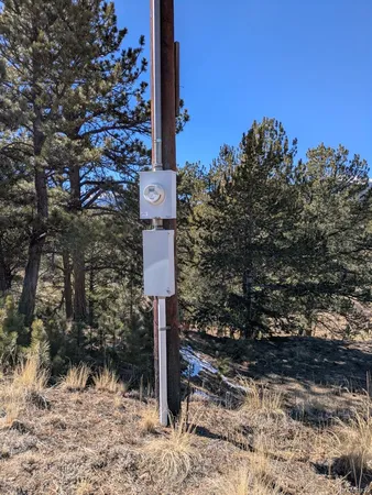 a street sign on a pole next to a road