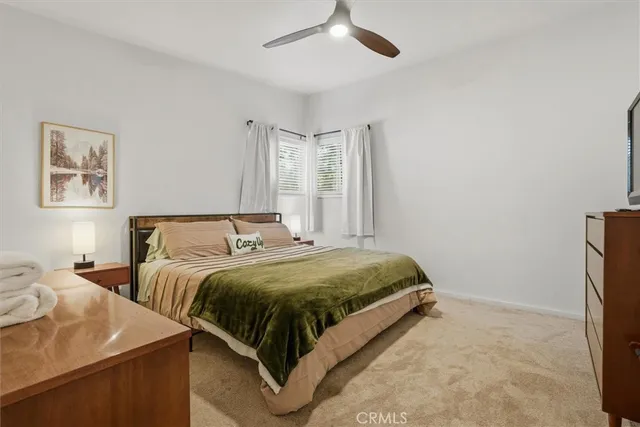 a bedroom with a bed and a painting on the wall