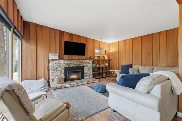 a living room with furniture a fireplace and a flat screen tv