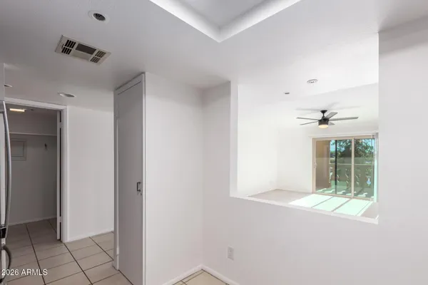 a view of hallway with windows and cabinet