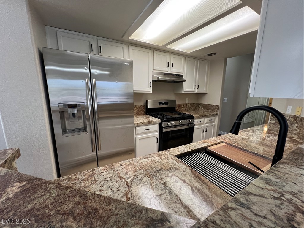 2975 Bluegrass Lane, Unit 424 Henderson, NV 89074 - Photo 10 of 43 Stainless steel double door refrigerator with ice/water in the door. Custom granite bar