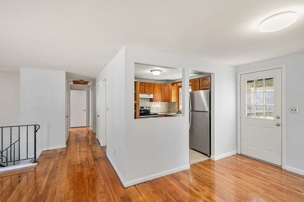 16 Blueview Road Boston, MA 02132 - Photo 11 of 33 a view of a big room with wooden floor and windows