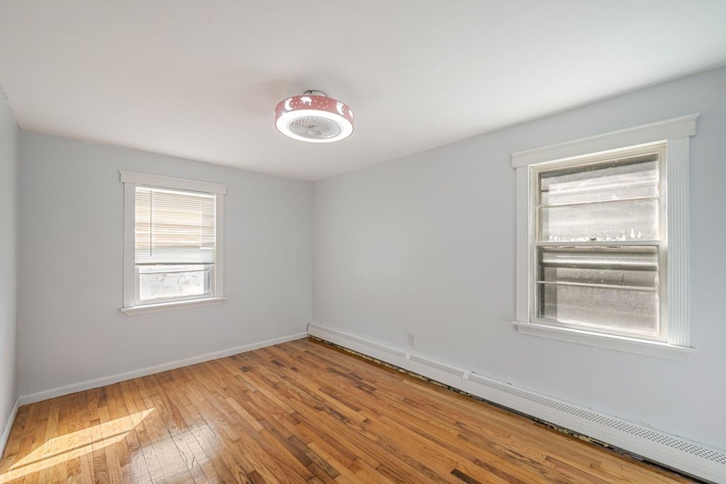 16 Blueview Road Boston, MA 02132 - Photo 14 of 33 a view of empty room with wooden floor and fan