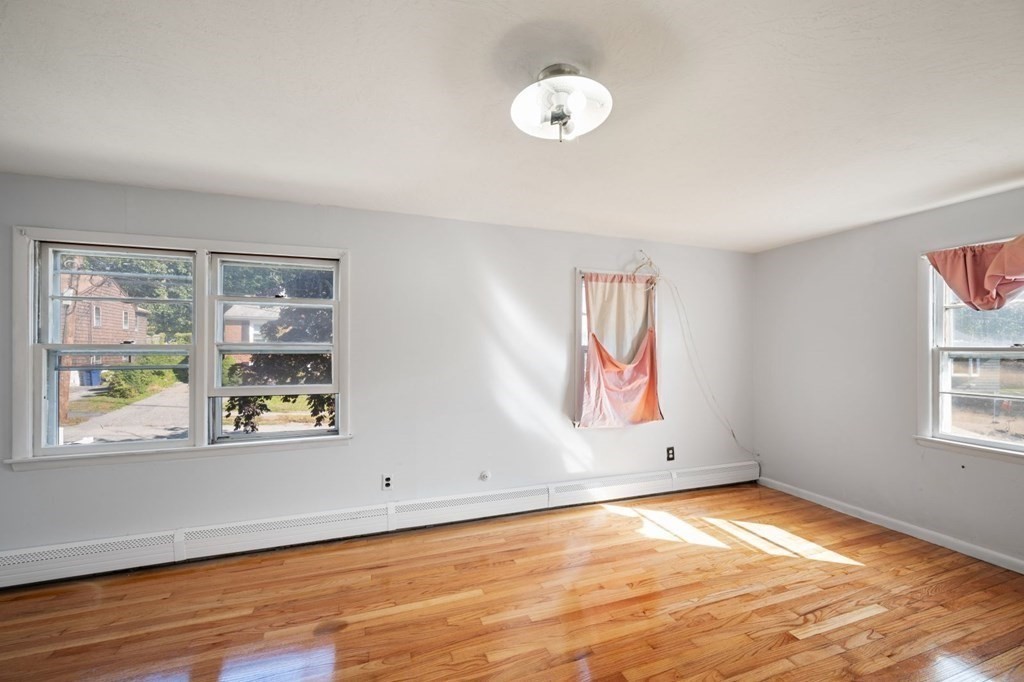 16 Blueview Road Boston, MA 02132 - Photo 16 of 33 a view of an empty room with wooden floor and a window
