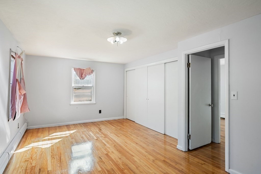 16 Blueview Road Boston, MA 02132 - Photo 17 of 33 a view of empty room with wooden floor