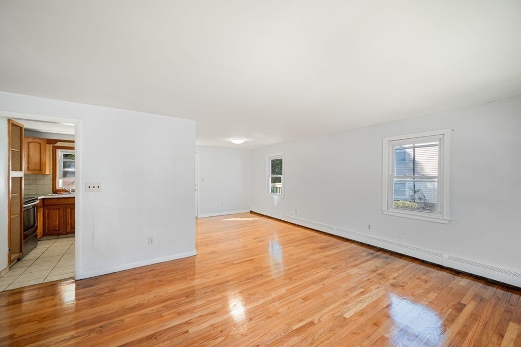 16 Blueview Road Boston, MA 02132 - Photo 6 of 33 a view of an empty room with wooden floor and a window