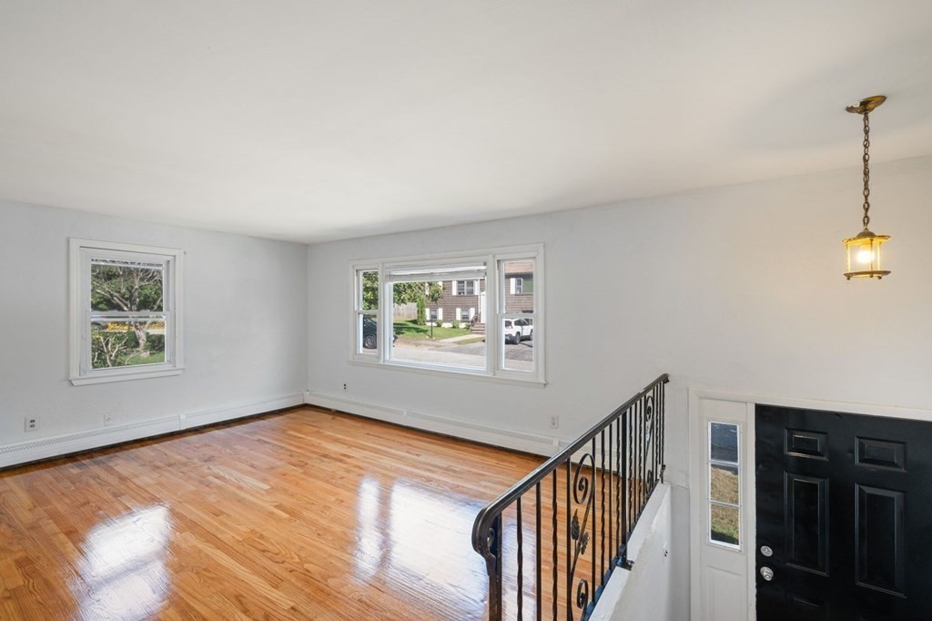 16 Blueview Road Boston, MA 02132 - Photo 7 of 33 a view of an empty room with window and stairs