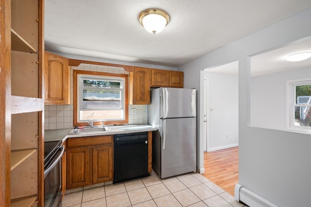 16 Blueview Road Boston, MA 02132 - Photo 8 of 33 a kitchen with a refrigerator a sink and dishwasher