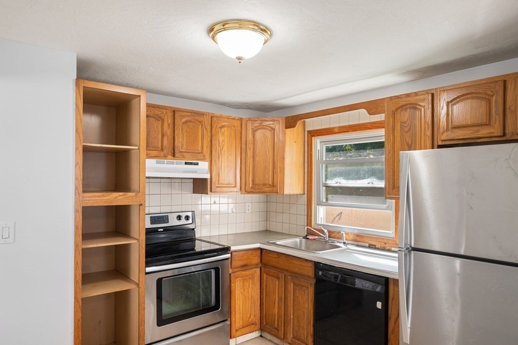 16 Blueview Road Boston, MA 02132 - Photo 9 of 33 a kitchen with stainless steel appliances granite countertop a refrigerator and a sink