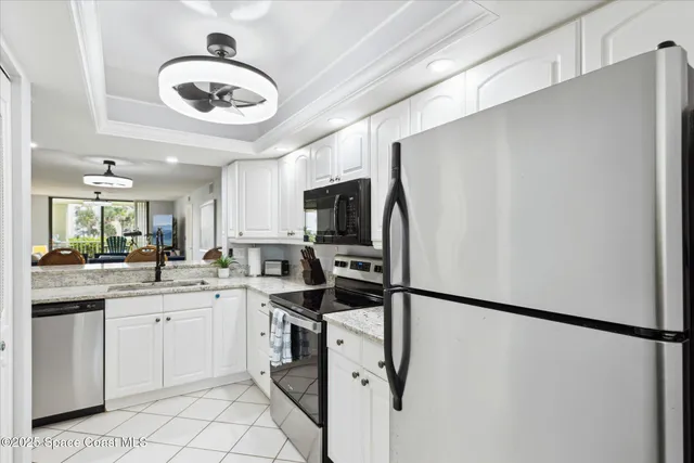 a kitchen with stainless steel appliances a refrigerator sink and cabinets
