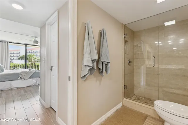 a bathroom with a shower a toilet and a sink