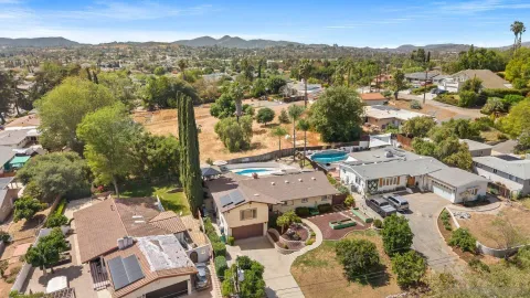 an aerial view of residential houses with outdoor space