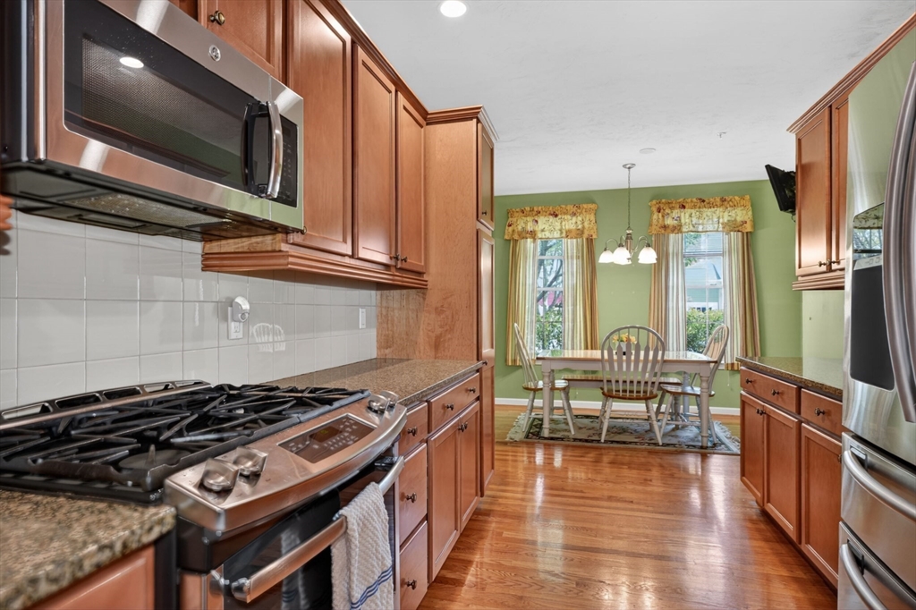 15 Hastings Road, Unit 15 Hudson, MA 01749 - Photo 13 of 40 a kitchen with wooden floor and a stove top oven