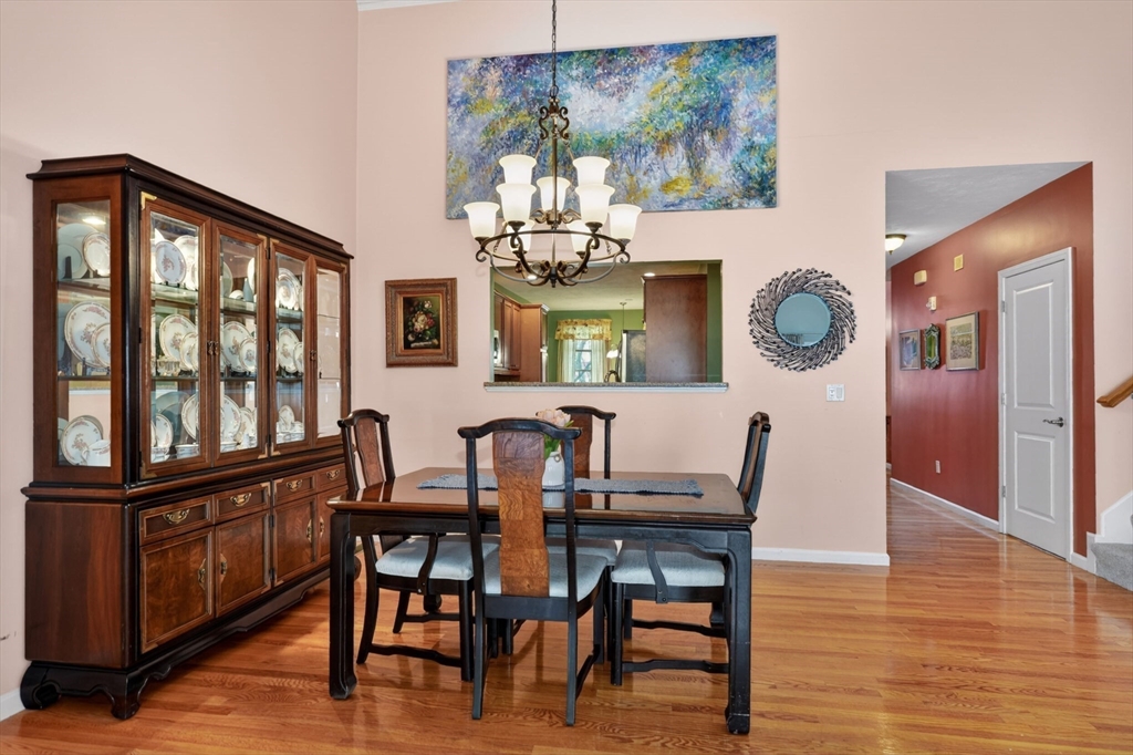 15 Hastings Road, Unit 15 Hudson, MA 01749 - Photo 15 of 40 a view of a dining room with furniture a chandelier and wooden floor