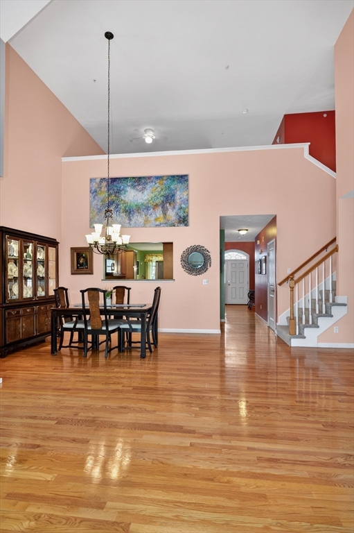 15 Hastings Road, Unit 15 Hudson, MA 01749 - Photo 16 of 40 a view of a dining room and livingroom with furniture wooden floor a chandelier