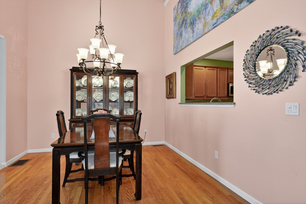 15 Hastings Road, Unit 15 Hudson, MA 01749 - Photo 17 of 40 a view of a dining room with furniture and chandelier