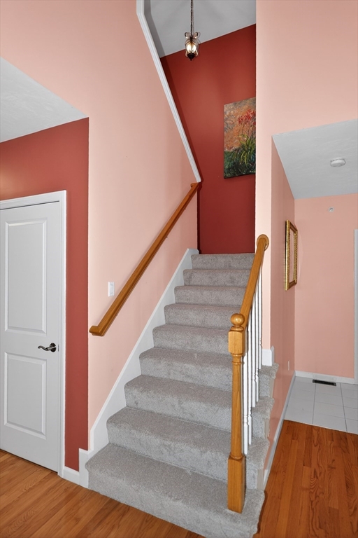 15 Hastings Road, Unit 15 Hudson, MA 01749 - Photo 30 of 40 a view of staircase with wooden floor and white walls