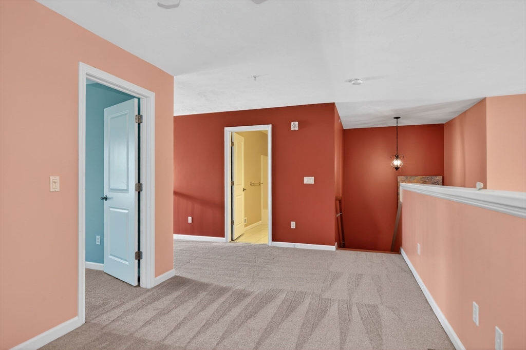 15 Hastings Road, Unit 15 Hudson, MA 01749 - Photo 34 of 40 a view of a hallway with wooden floor