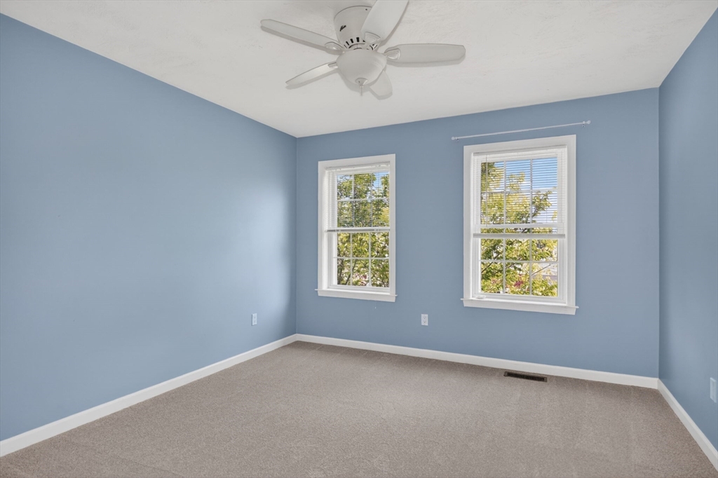 15 Hastings Road, Unit 15 Hudson, MA 01749 - Photo 36 of 40 an empty room with windows and fan