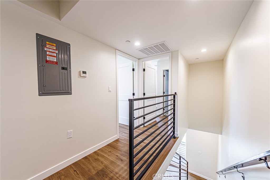 1859 1/2 South Crenshaw Boulevard Los Angeles, CA 90019 - Photo 17 of 29 a view of a hallway with wooden floor and staircase