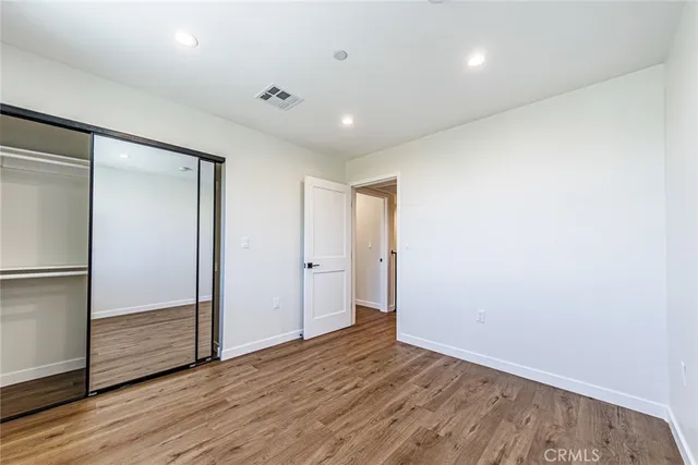 a view of room with wooden floor and window
