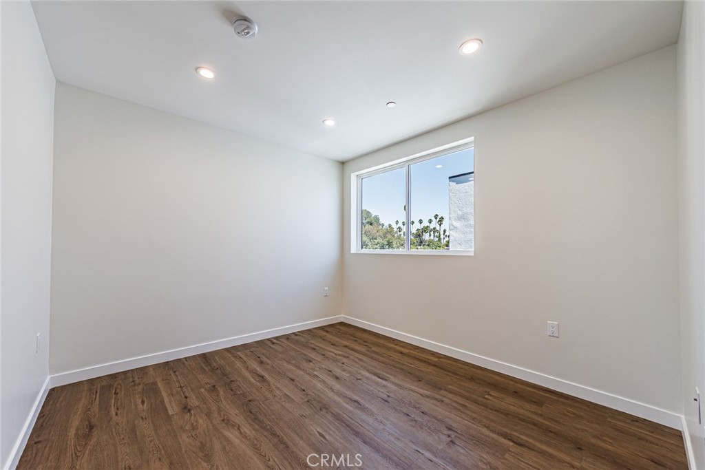 1859 1/2 South Crenshaw Boulevard Los Angeles, CA 90019 - Photo 22 of 29 a view of room with wooden floor and window