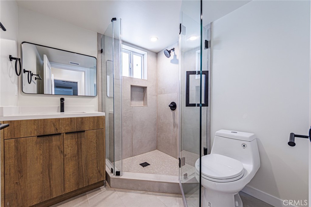 1859 1/2 South Crenshaw Boulevard Los Angeles, CA 90019 - Photo 24 of 29 a bathroom with a toilet sink and shower