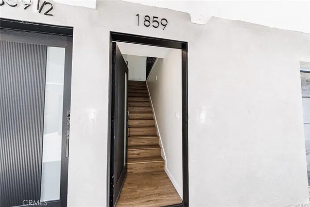 a view of a hallway with wooden floor
