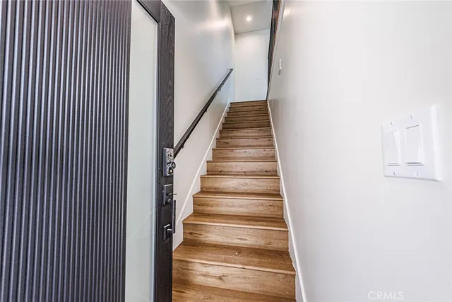 a kitchen with stainless steel appliances a sink and a wooden floor