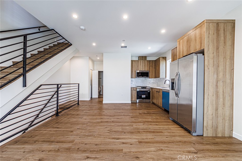 1859 1/2 South Crenshaw Boulevard Los Angeles, CA 90019 - Photo 8 of 29 a kitchen with stainless steel appliances a refrigerator and a stove top oven