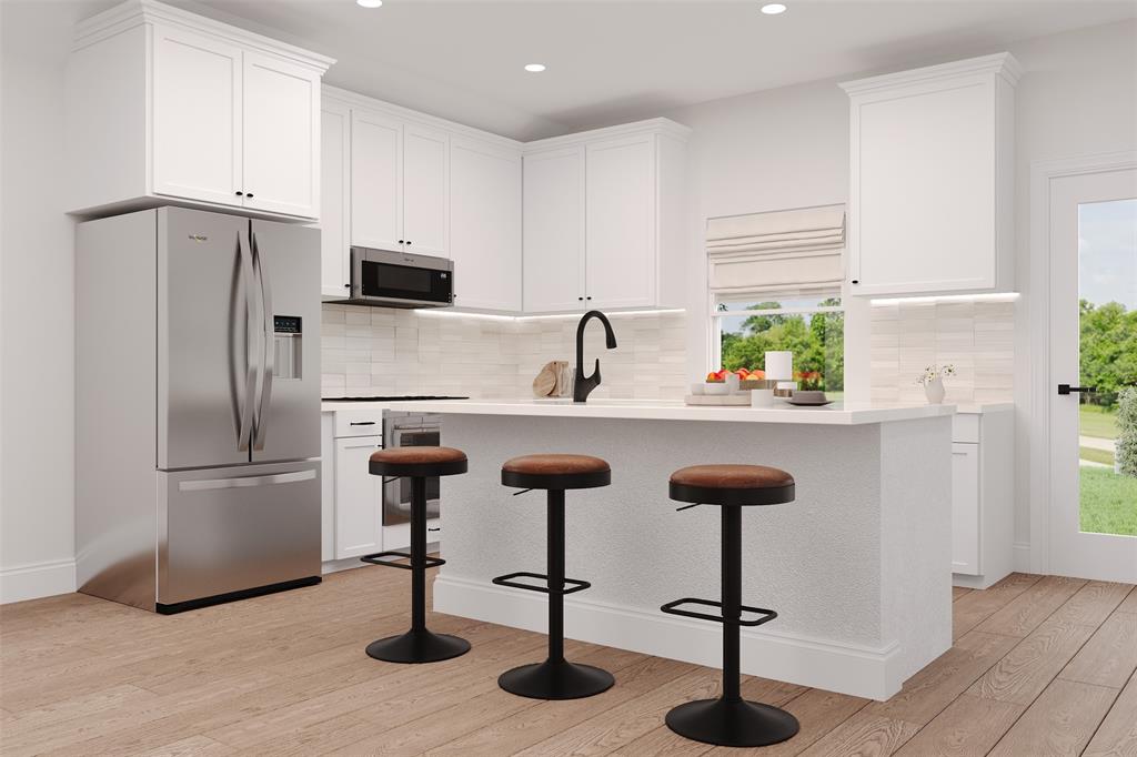 9009 Saratoga Street Pilot Point, TX 76258 - Photo 2 of 6 a kitchen with cabinets and stainless steel appliances