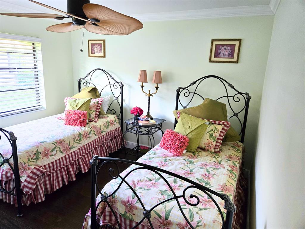 8223 Springlake Drive, Unit 8223 Boca Raton, FL 33496 - Photo 11 of 14 a bedroom with two beds and a chandelier