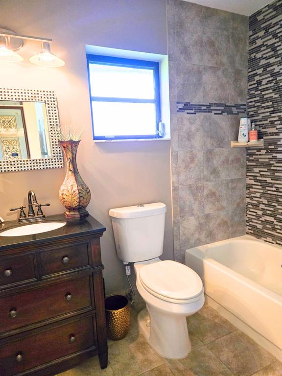 8223 Springlake Drive, Unit 8223 Boca Raton, FL 33496 - Photo 12 of 14 a bathroom with a toilet a sink and a bathtub