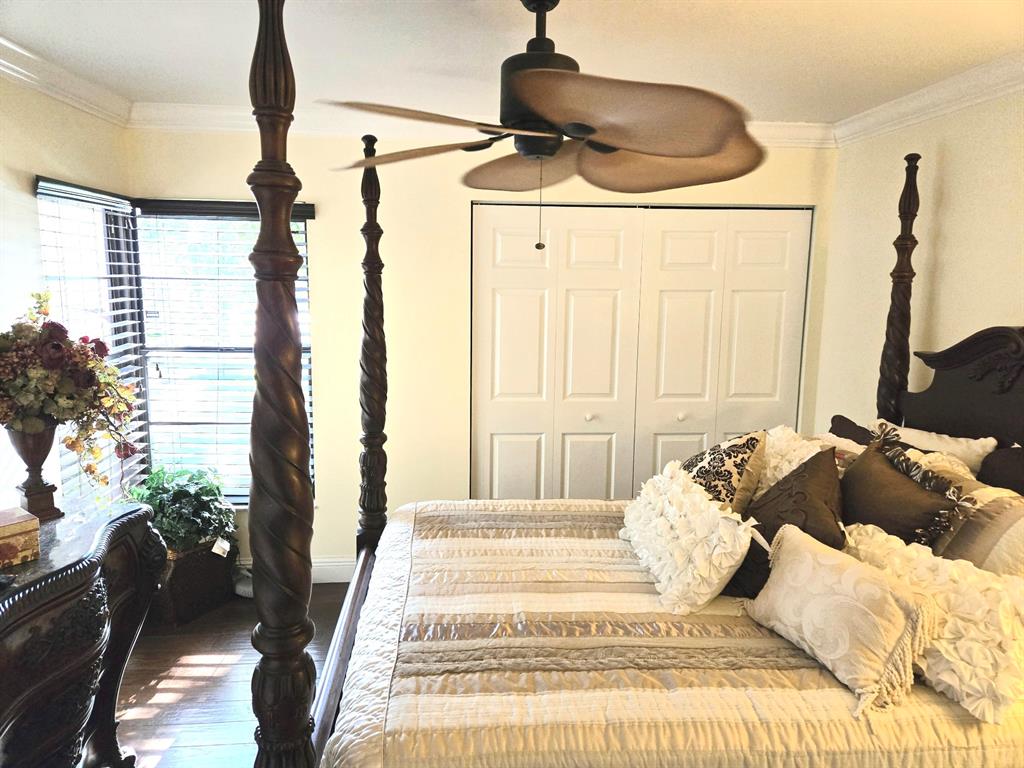 8223 Springlake Drive, Unit 8223 Boca Raton, FL 33496 - Photo 13 of 14 a bedroom with a bed and a chandelier