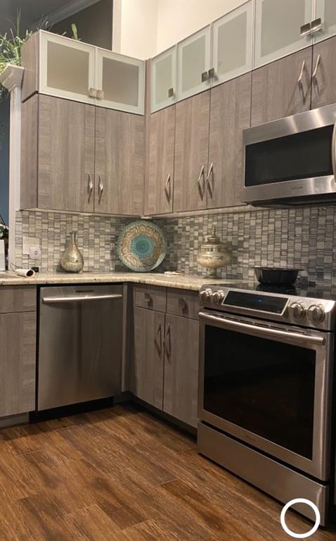 8223 Springlake Drive, Unit 8223 Boca Raton, FL 33496 - Photo 5 of 14 a kitchen with stainless steel appliances a stove a sink and a microwave