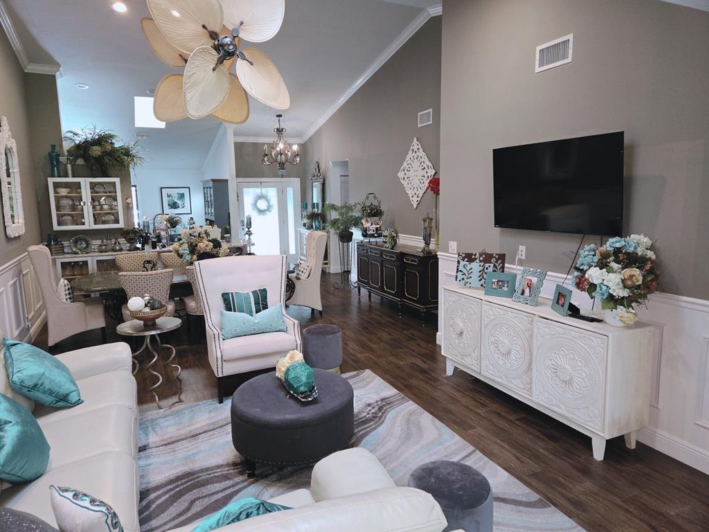 8223 Springlake Drive, Unit 8223 Boca Raton, FL 33496 - Photo 8 of 14 a living room with furniture chandelier and a flat screen tv