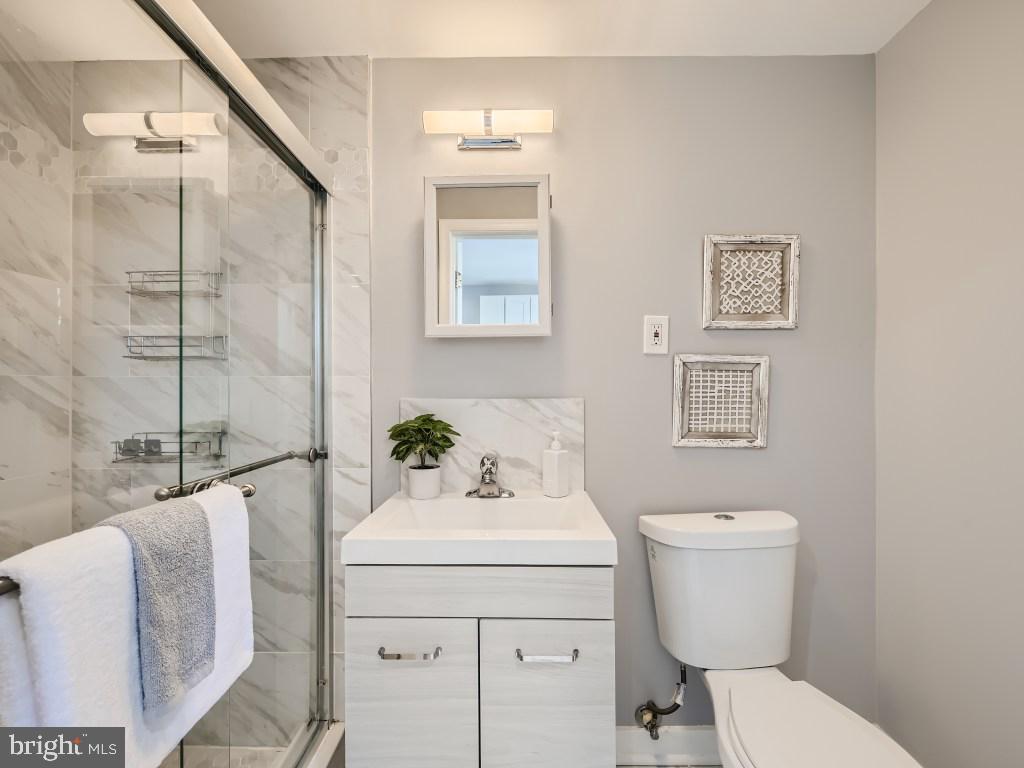 1402 Carroll Street Baltimore, MD 21230 - Photo 15 of 28 a bathroom with a sink toilet and shower