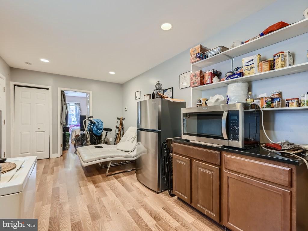 1402 Carroll Street Baltimore, MD 21230 - Photo 21 of 28 a living room with furniture and a flat screen tv