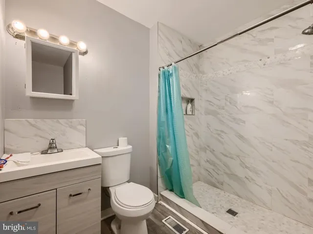 a bathroom with a sink toilet and shower