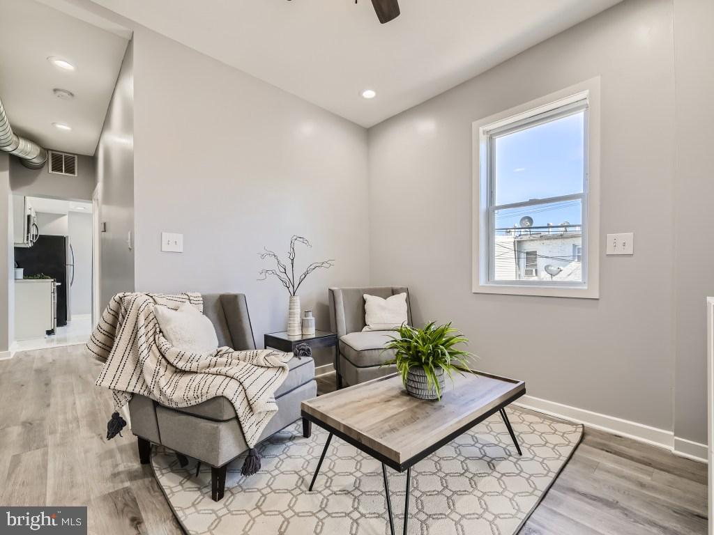 1402 Carroll Street Baltimore, MD 21230 - Photo 4 of 28 a bedroom with furniture and a potted plant