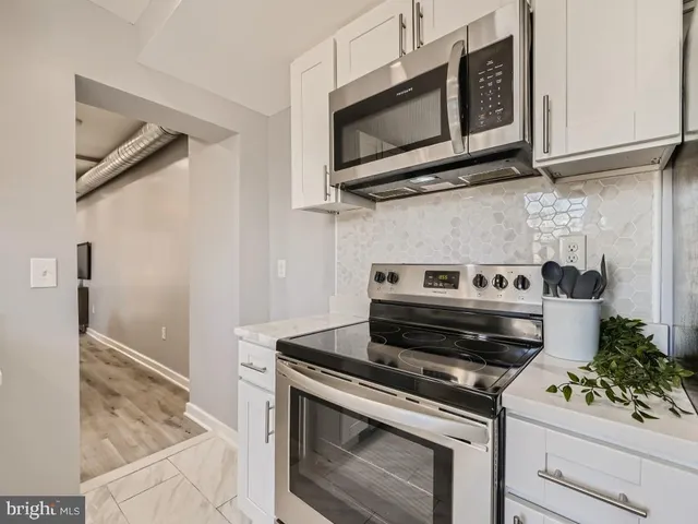 a stove top oven sitting inside of a kitchen