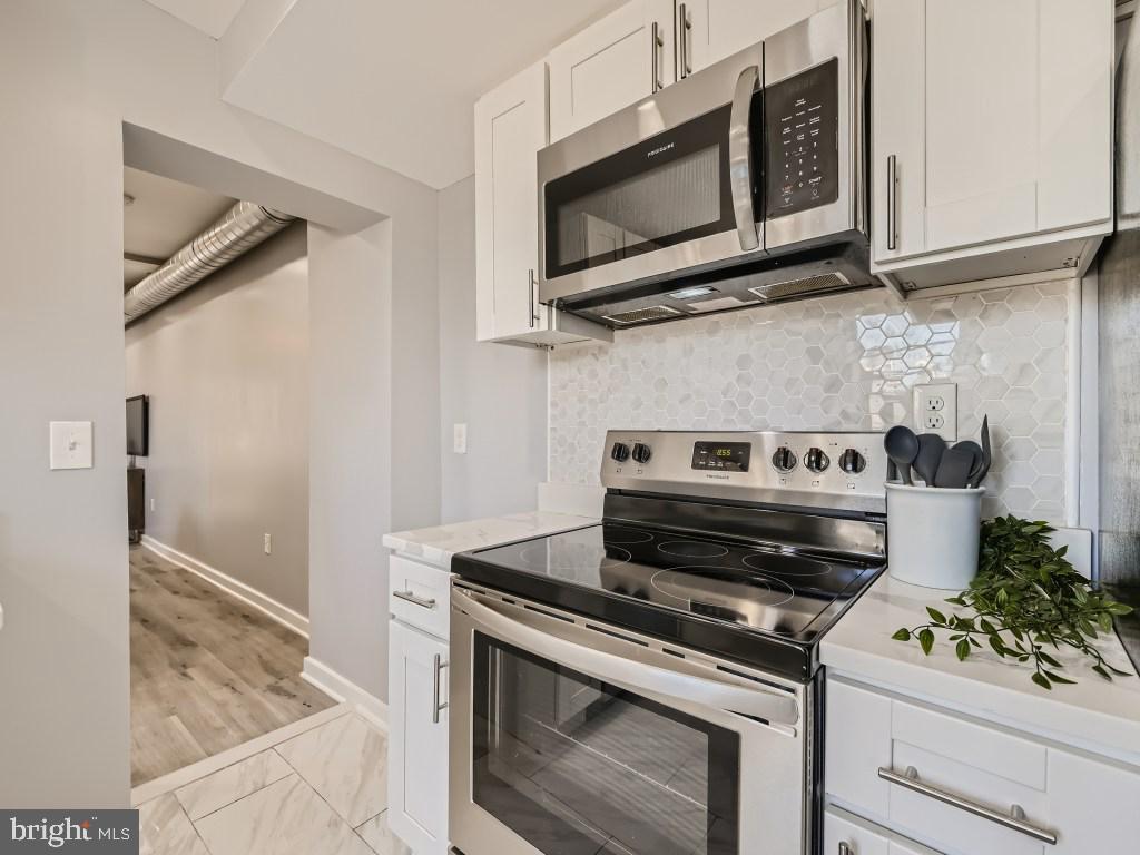 1402 Carroll Street Baltimore, MD 21230 - Photo 9 of 28 a stove top oven sitting inside of a kitchen
