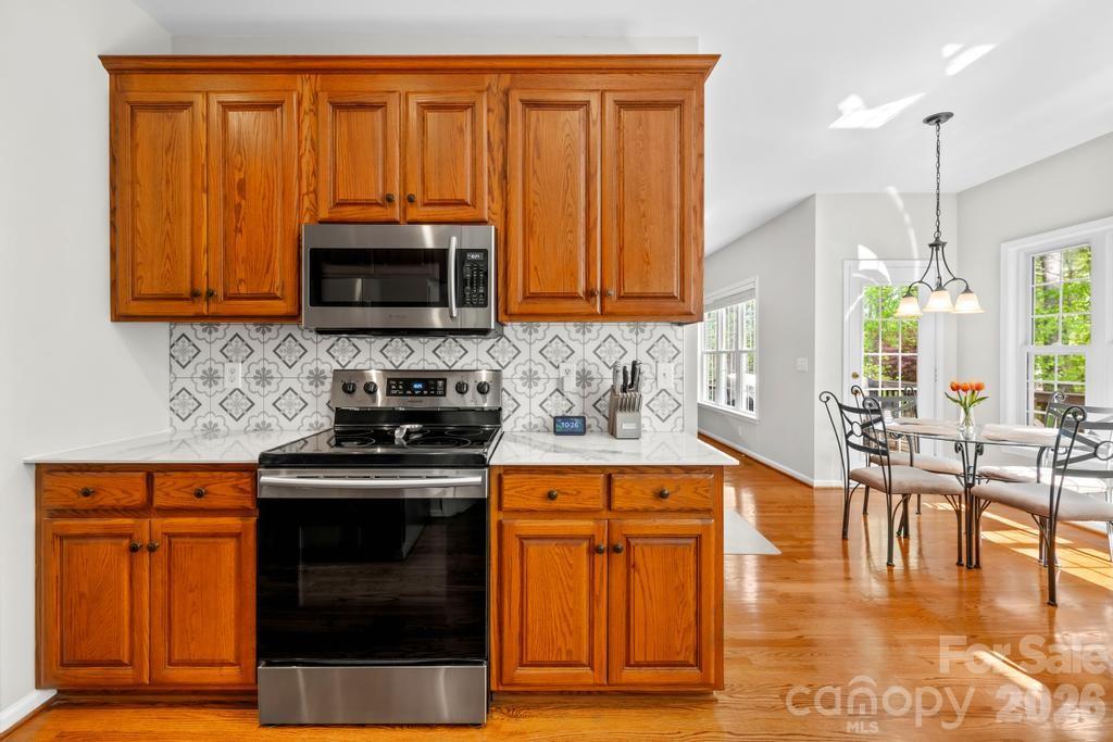 17028 Hampton Trace Road Huntersville, NC 28078 - Photo 14 of 41 a kitchen with stainless steel appliances granite countertop a stove a sink and a microwave