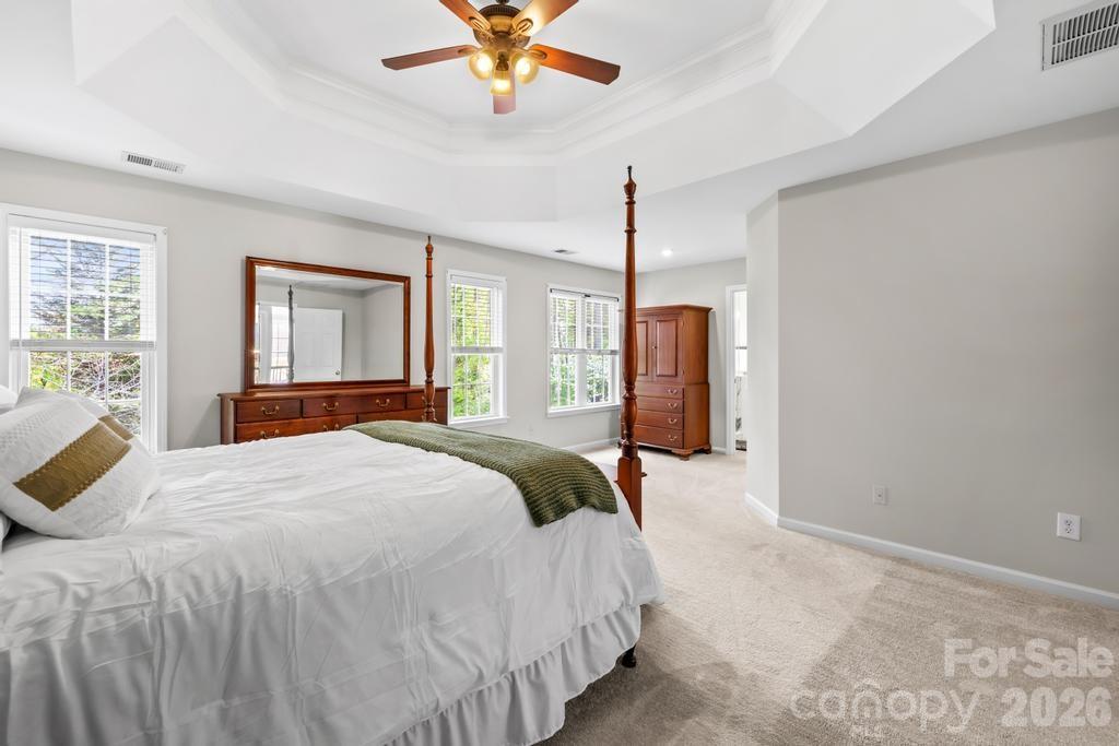 17028 Hampton Trace Road Huntersville, NC 28078 - Photo 20 of 41 a bedroom with a bed and a chandelier